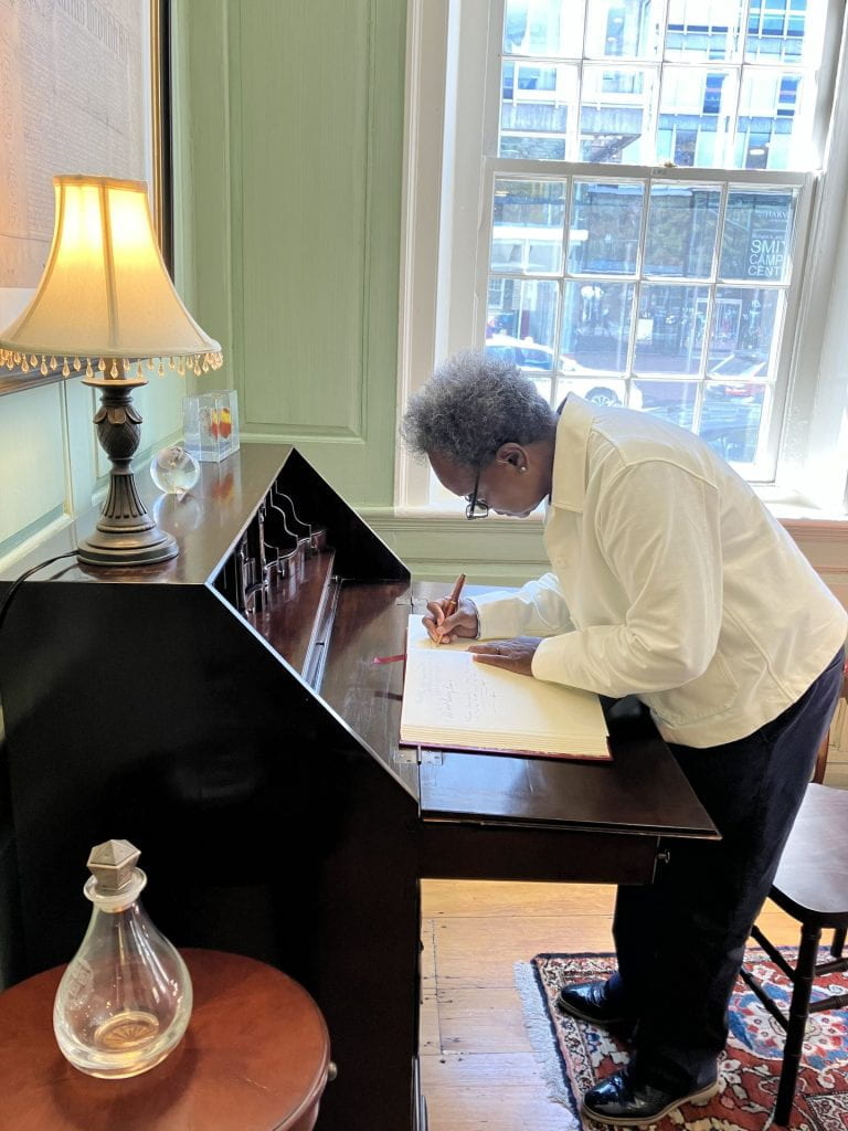 Lori Lightfoot signs the Harvard University Guest Book.